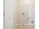 Practical laundry room with essential connections and overhead rack, simplifying chores and storage at 3335 Thornbridge Dr, Powder Springs, GA 30127