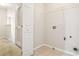 Convenient laundry room with hookups, shelving and tile floors for easy cleaning at 3335 Thornbridge Dr, Powder Springs, GA 30127