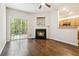Bright living area with a fireplace, hardwood floors, and access to the outdoors through sliding doors at 3335 Thornbridge Dr, Powder Springs, GA 30127