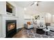 Cozy living room with a fireplace and hardwood floors with an open concept dining room and plenty of natural light at 3335 Thornbridge Dr, Powder Springs, GA 30127