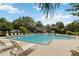 Community pool surrounded by lounge chairs, mature landscaping, and clubhouse in a tranquil setting at 3335 Thornbridge Dr, Powder Springs, GA 30127