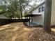 Well-kept backyard with a covered patio, a privacy fence and mature trees surrounding the property at 5090 Lorraine Pl, Forest Park, GA 30297
