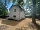 A view of the backyard with a well-maintained lawn and privacy fencing, surrounded by mature trees at 5090 Lorraine Pl, Forest Park, GA 30297