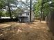 Spacious backyard featuring privacy fence, mature trees and a covered patio providing an outdoor retreat at 5090 Lorraine Pl, Forest Park, GA 30297