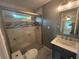 Updated bathroom featuring a glass-enclosed shower with decorative tile and modern vanity at 5090 Lorraine Pl, Forest Park, GA 30297