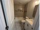 Modern bathroom featuring tiled walls, updated vanity and hardware, and a shower-over-tub design at 5090 Lorraine Pl, Forest Park, GA 30297