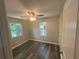 Comfortable bedroom featuring wood-look flooring, modern ceiling fan and two windows at 5090 Lorraine Pl, Forest Park, GA 30297
