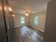 Comfortable bedroom featuring wood-look flooring, modern ceiling fan, and great closet space at 5090 Lorraine Pl, Forest Park, GA 30297