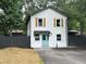 Charming two-story home with white siding, wood shutters, gray fence and inviting light blue front door at 5090 Lorraine Pl, Forest Park, GA 30297