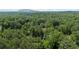 Aerial view of a wooded area with Stone Mountain in the distance on a sunny day at 5632 Stillwater Ct, Stone Mountain, GA 30087