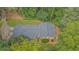 Aerial view of home, showing roof, landscaping, and surrounding trees at 5632 Stillwater Ct, Stone Mountain, GA 30087