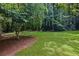 Lush green backyard featuring mature trees and serene natural surroundings at 5632 Stillwater Ct, Stone Mountain, GA 30087
