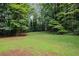Large backyard surrounded by lush trees, offering a peaceful retreat and natural privacy at 5632 Stillwater Ct, Stone Mountain, GA 30087