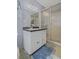 Bathroom features a modern vanity with a white sink and a glass-enclosed shower with patterned tiles at 5632 Stillwater Ct, Stone Mountain, GA 30087