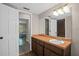 Bathroom with brown vanity offers a large mirror, ample counter space, and convenient access to other rooms at 5632 Stillwater Ct, Stone Mountain, GA 30087