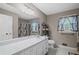 Bathroom featuring a long white countertop, mirrored wall, and patterned shower curtain at 5632 Stillwater Ct, Stone Mountain, GA 30087