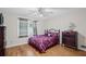 Cozy bedroom features hardwood floors, ceiling fan, and a classic dark wood dresser for ample storage at 5632 Stillwater Ct, Stone Mountain, GA 30087