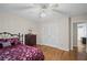 Bright bedroom with hardwood floors features a closet with louvered doors and neutral walls at 5632 Stillwater Ct, Stone Mountain, GA 30087