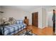 Bright bedroom features hardwood floors, a comfortable bed, and convenient access to the hallway at 5632 Stillwater Ct, Stone Mountain, GA 30087