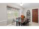 Cozy breakfast nook featuring a dark wood table set, large window, and stylish decor at 5632 Stillwater Ct, Stone Mountain, GA 30087