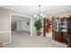 Traditional dining room with neutral walls, chandelier, and decorative cabinet, offering a warm, inviting space at 5632 Stillwater Ct, Stone Mountain, GA 30087