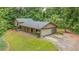 Beautiful two-story home with a garage surrounded by mature trees and lush green lawn at 5632 Stillwater Ct, Stone Mountain, GA 30087