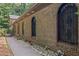 Brick exterior with arched windows, a side path, and meticulous landscaping at 5632 Stillwater Ct, Stone Mountain, GA 30087