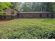 Beautiful two-story home with lush green lawn surrounded by plants and mature trees at 5632 Stillwater Ct, Stone Mountain, GA 30087