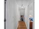 Hallway with hardwood flooring and neutral walls leading to various rooms at 5632 Stillwater Ct, Stone Mountain, GA 30087