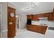 The kitchen is equipped with wooden cabinets, modern appliances, white countertops, and a stainless steel sink at 5632 Stillwater Ct, Stone Mountain, GA 30087