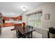 Kitchen and breakfast nook featuring a dark wood table set, wooden cabinets, modern appliances, and a large window at 5632 Stillwater Ct, Stone Mountain, GA 30087
