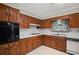 The kitchen is equipped with wooden cabinets, modern appliances, white countertops, and a stainless steel sink at 5632 Stillwater Ct, Stone Mountain, GA 30087