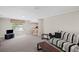Carpeted living room offers a relaxed seating area, and a window that provides natural light at 5632 Stillwater Ct, Stone Mountain, GA 30087