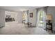 Neutral living room with large windows, decorative curtains, and open access to a dining area at 5632 Stillwater Ct, Stone Mountain, GA 30087