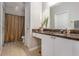 Well-lit bathroom featuring marble counters, white cabinets, and a shower at 10 Perimeter Summit Ne Blvd # 4223, Brookhaven, GA 30319