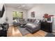 Bright living room features gray sofa and view of community landscaping at 10 Perimeter Summit Ne Blvd # 4223, Brookhaven, GA 30319