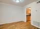 Dining room area leading to kitchen with natural hardwood floors and neutral trim at 1150 Collier Nw Rd # 10L, Atlanta, GA 30318