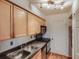 Compact kitchen featuring stainless appliances, granite countertops and light wood cabinetry at 1150 Collier Nw Rd # 10L, Atlanta, GA 30318