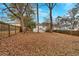 Spacious backyard with mature trees and partial view of neighboring houses at 1222 E Forrest Ave, Atlanta, GA 30344