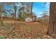 Large fenced backyard featuring mature trees and a view of the back of the house at 1222 E Forrest Ave, Atlanta, GA 30344