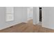 This bedroom features wood-look flooring, white walls, a window, and a bathroom at 1222 E Forrest Ave, Atlanta, GA 30344