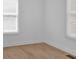 Bright bedroom with two windows, white walls and light wood laminate flooring at 1222 E Forrest Ave, Atlanta, GA 30344