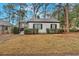 Attractive single-story home with a well-manicured front lawn and mature trees at 1222 E Forrest Ave, Atlanta, GA 30344