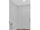 Hallway with light walls, white door, and wood-look flooring at 1222 E Forrest Ave, Atlanta, GA 30344