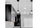 This modern kitchen features black cabinets, white countertops, pendant lighting, and a stylish backsplash at 1222 E Forrest Ave, Atlanta, GA 30344