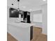 This modern kitchen features black cabinets, white countertops, pendant lighting, and a stylish backsplash at 1222 E Forrest Ave, Atlanta, GA 30344