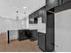 This modern kitchen features black cabinets, white countertops, pendant lighting, and a stylish backsplash at 1222 E Forrest Ave, Atlanta, GA 30344