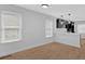 Bright living room featuring wood-look flooring, white walls, and an open layout to the modern kitchen at 1222 E Forrest Ave, Atlanta, GA 30344