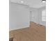 Bright living room featuring wood-look flooring, white walls, and access to the front entrance at 1222 E Forrest Ave, Atlanta, GA 30344