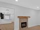 Modern fireplace and adjoining kitchen in this house's open living space at 1222 E Forrest Ave, Atlanta, GA 30344